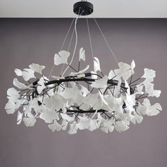 Modern chandelier pendant lamp with white ginkgo leaf design on black rings, suspended by cables