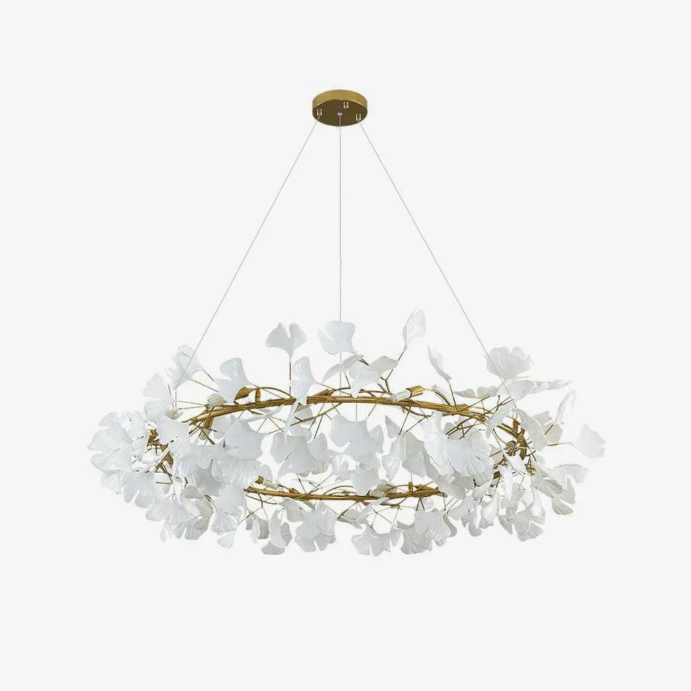 Modern gold pendant chandelier with white gingko leaf design hanging from ceiling