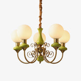 Modern chandelier with six white glass globes, gold metal arms, and green accents hanging lamp