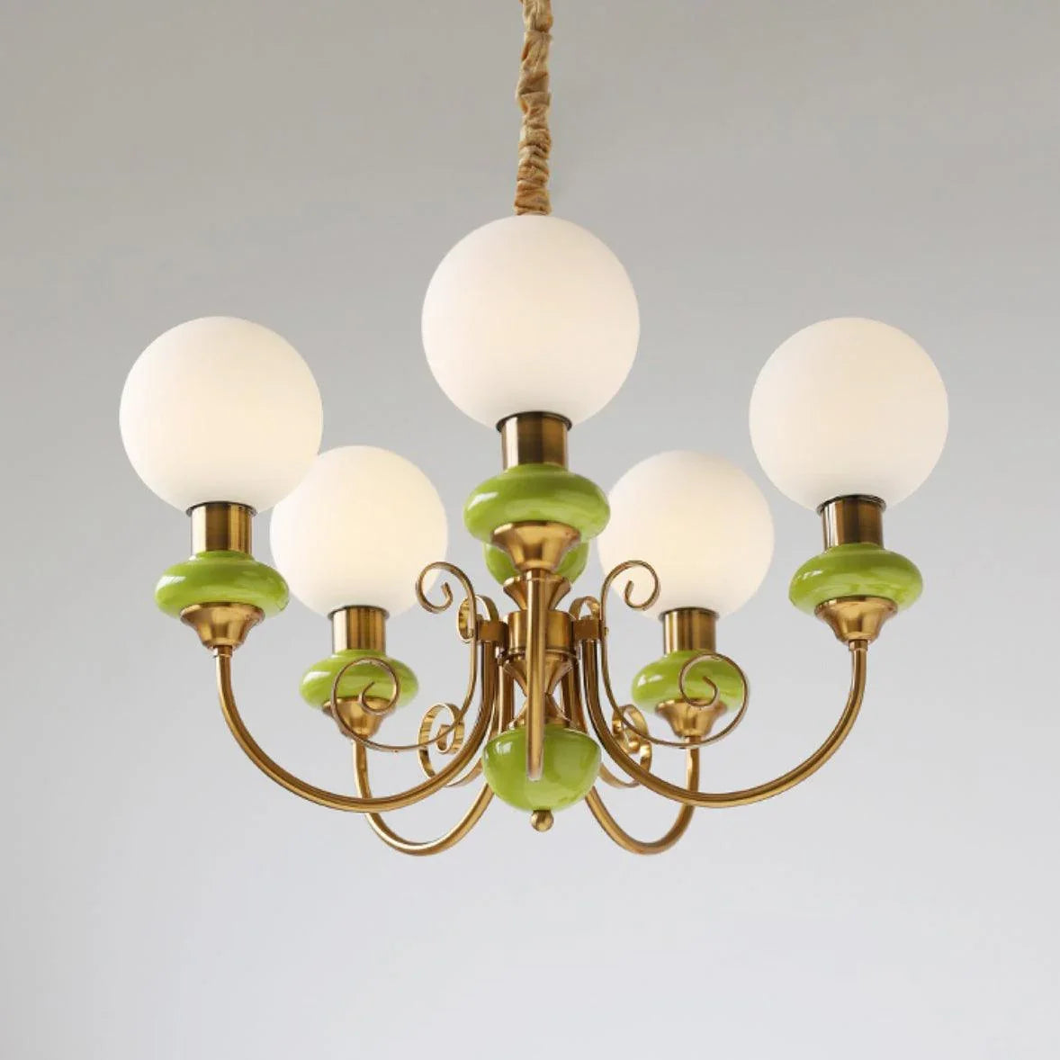 Modern chandelier with five white globe lights and gold-green metal frame by YH Lamps