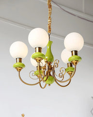 Modern chandelier with five white glass globes, gold metal arms, and green ceramic accents hanging from ceiling
