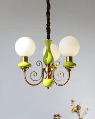 Modern chandelier with three white globe lamps, gold frame, and lime green decorative accents