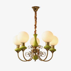 Modern six-light chandelier with green ceramic and gold metal arms, white glass globes, suspended by gold fixture