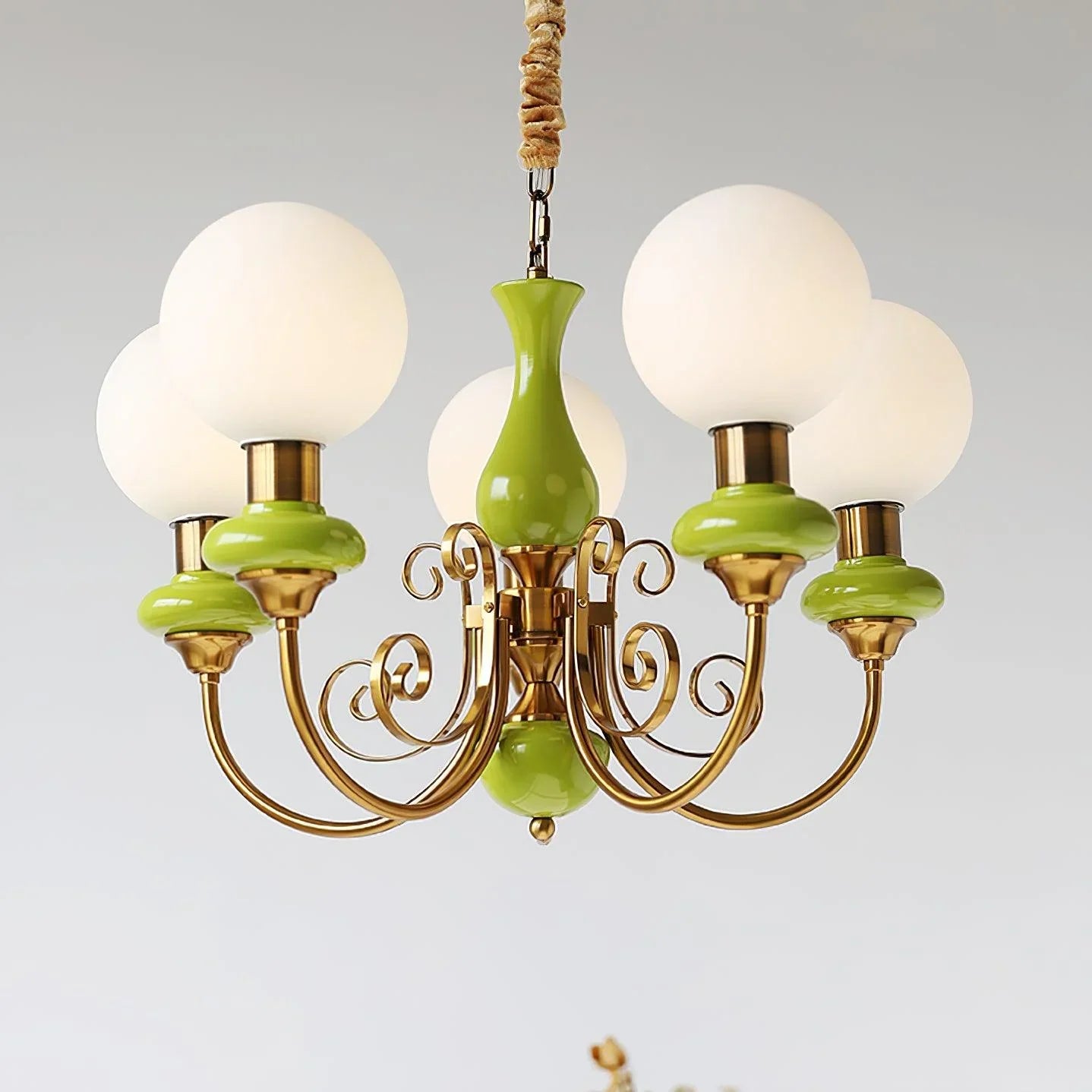 Modern chandelier with five white globe lampshades and green gold metal arms, elegant pendant light