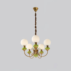 Elegant chandelier with six white globe lights, green and gold metal accents, hanging lamp from ceiling