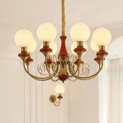 Elegant six-light chandelier with brass and wood accents, frosted white globe shades, modern home lighting