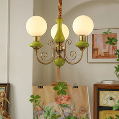 YH Lamps modern 3-head pendant chandelier with green and gold accents, white globe light shades in cozy room