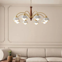 Swedish modern brass chandelier with nine white flower-shaped lampshades hanging over beige sofa in elegant living room