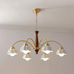 Modern chandelier with six curved brass arms, white scalloped lampshades, and walnut wood central fixture