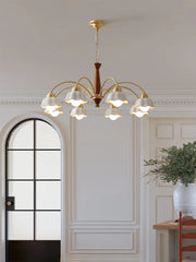 Modern brass chandelier with nine white scalloped glass shades and walnut wood accent in elegant dining room