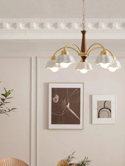 Modern brass and walnut wood chandelier with six white scalloped shades in elegant living room