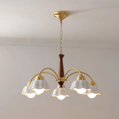 Modern brass and walnut wood chandelier with six curved arms and white petal-shaped lampshades