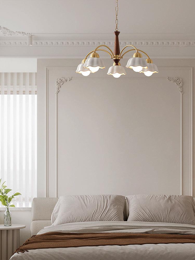 Modern Swedish chandelier pendant lamp with brass and walnut wood, floral white shades, hanging in elegant bedroom