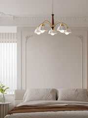 Modern Swedish chandelier pendant lamp with brass and walnut wood, floral white shades, hanging in elegant bedroom