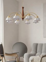 Modern brass chandelier pendant lamp with six white scalloped glass shades in minimalist living room