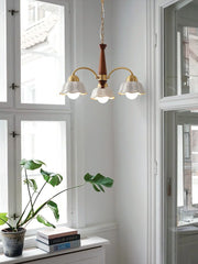 Modern 3-head brass and walnut wood pendant chandelier with white flower-shaped shades in Scandinavian style