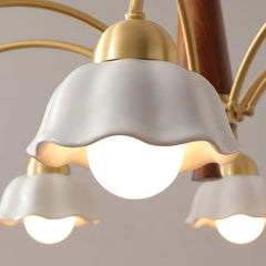 Modern chandelier with three white ceramic petal-shaped shades, brass fixtures, and walnut wood accents