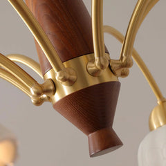Close-up of YH Lamps modern chandelier in brass and walnut wood with curved arms and detailed craftsmanship
