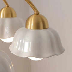 Close-up of modern pendant lamp with white scalloped glass shade and brass fixture against beige wall