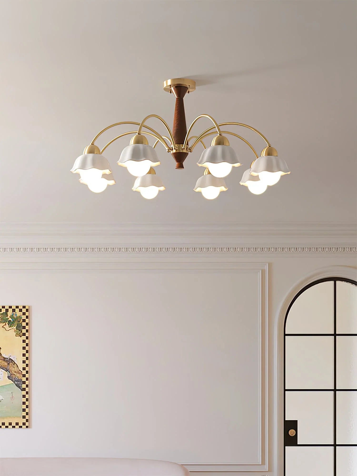 Modern ceiling chandelier with eight brass arms and white scalloped lampshades in elegant living room