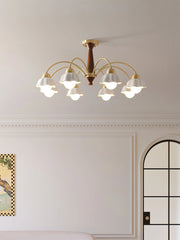 Modern ceiling chandelier with eight brass arms and white scalloped lampshades in elegant living room