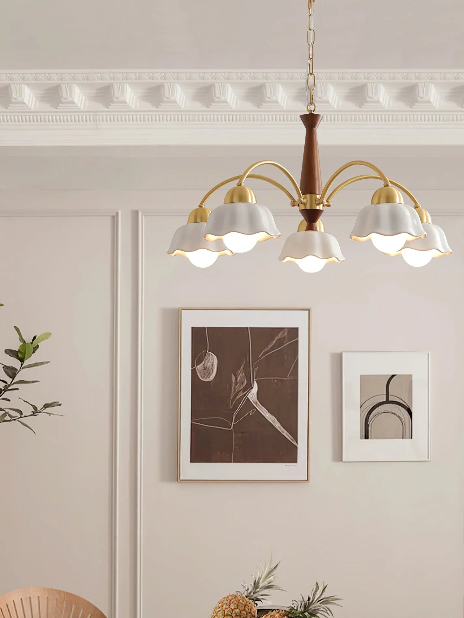 Modern brass and walnut wood chandelier with three white scalloped lampshades in elegant dining room