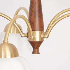 Modern Swedish-style pendant chandelier with walnut wood and brass arms, white glass shades