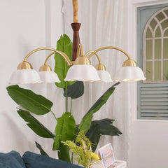 Modern 3-head brass chandelier with white petal-shaped shades in a stylish living room with green plants