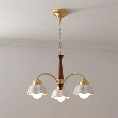 Modern 3-head brass chandelier with white flower-shaped shades and walnut wood details