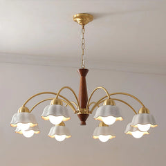 Modern chandelier with 8 white flower-shaped lampshades on brass arms and walnut wood center, hanging from ceiling