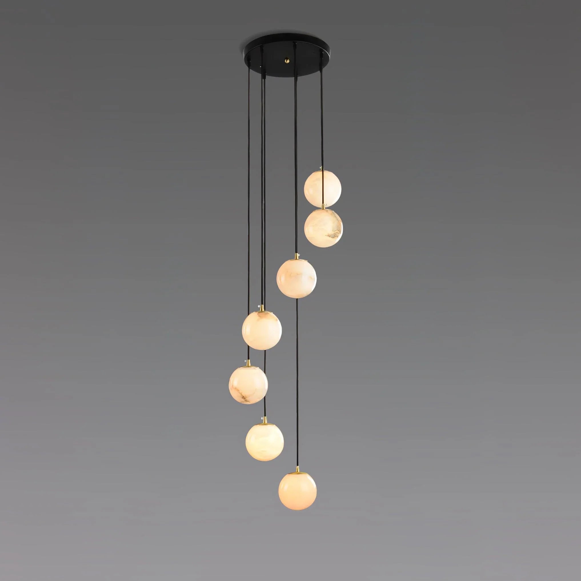 Modern chandelier with seven alabaster ball pendant lights hanging from round black canopy