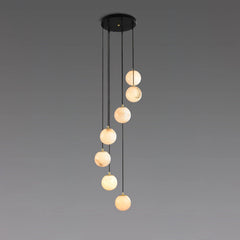 Modern chandelier with seven alabaster ball pendant lights hanging from round black canopy