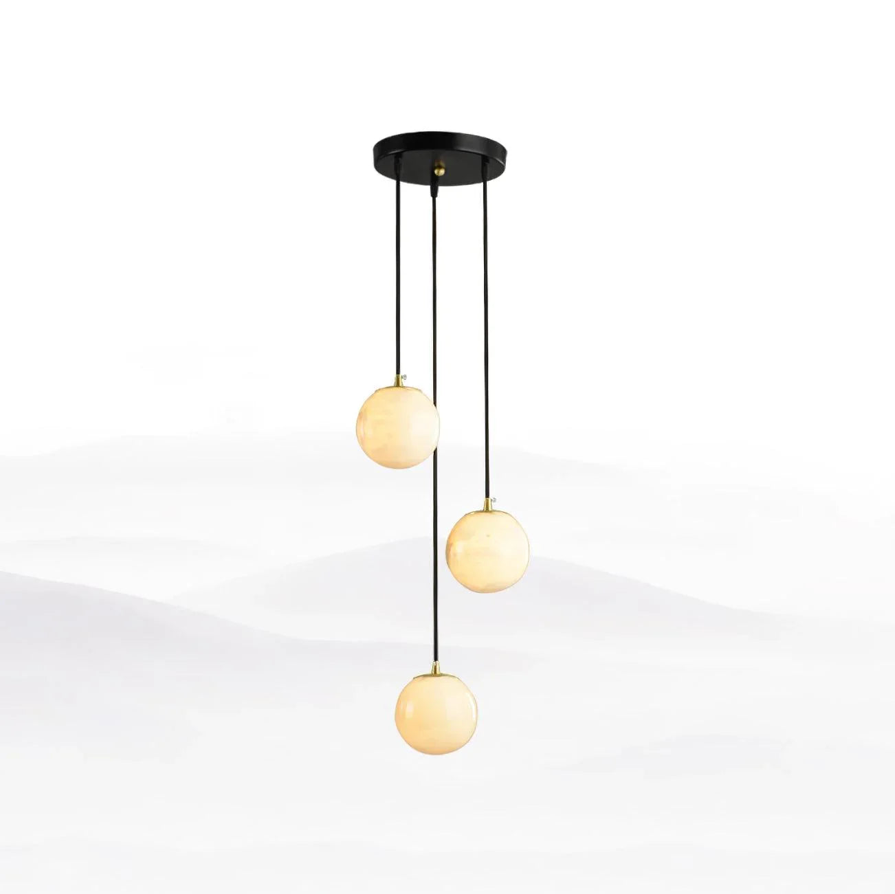 Modern pendant chandelier with three alabaster ball lights hanging from black round canopy