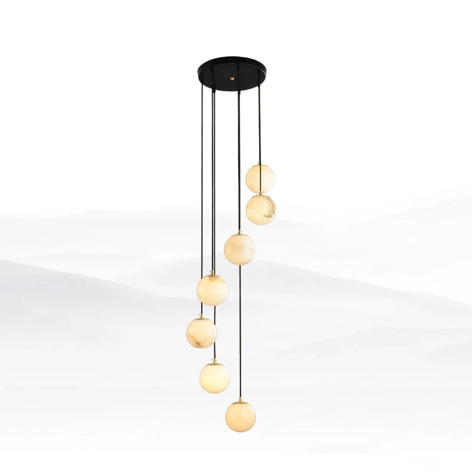 Modern chandelier with seven alabaster globe pendant lights hanging from a round black canopy