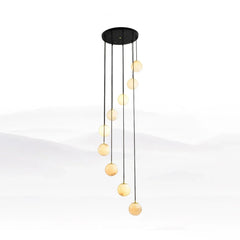 Modern pendant chandelier with nine alabaster glass globe lights hanging in staggered lengths from a black round ceiling canopy
