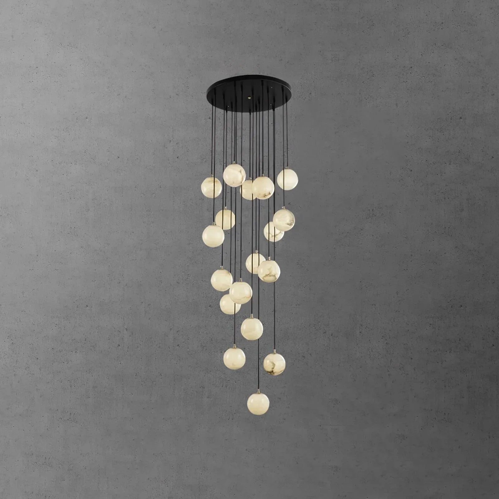 Modern cluster chandelier with round alabaster ball pendants hanging from a black round canopy