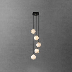 Modern black pendant chandelier with five alabaster ball lights hanging in staggered lengths