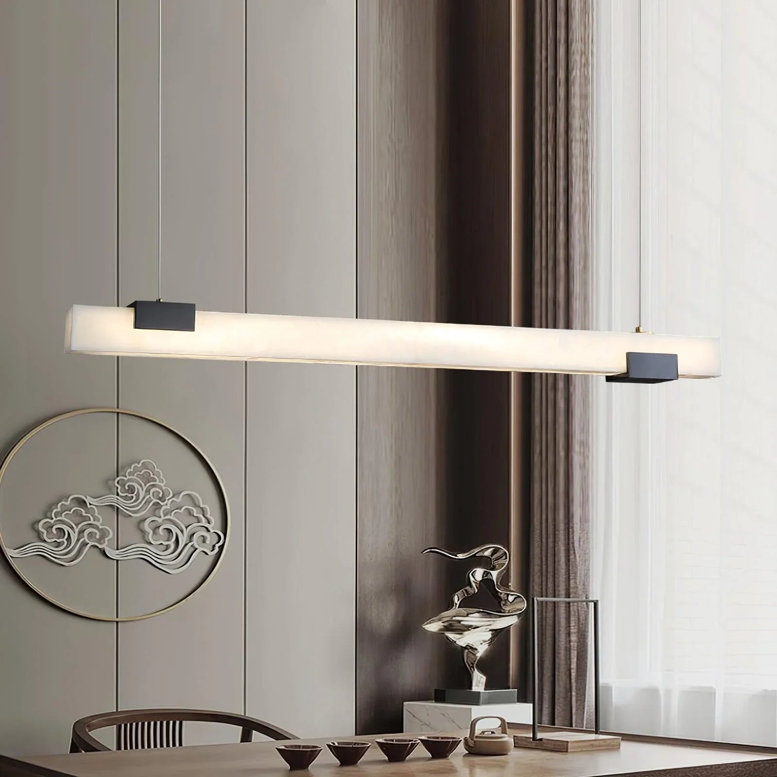 Modern pendant lamp with alabaster-style light and black accents hanging over wooden dining table in minimalist interior