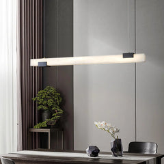 Modern rectangular black and white pendant lamp with warm light over dining table, minimalist decor
