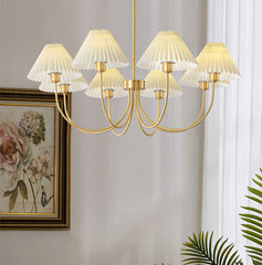 Modern brass chandelier with pleated white shades in a stylish living room, YH Lamps