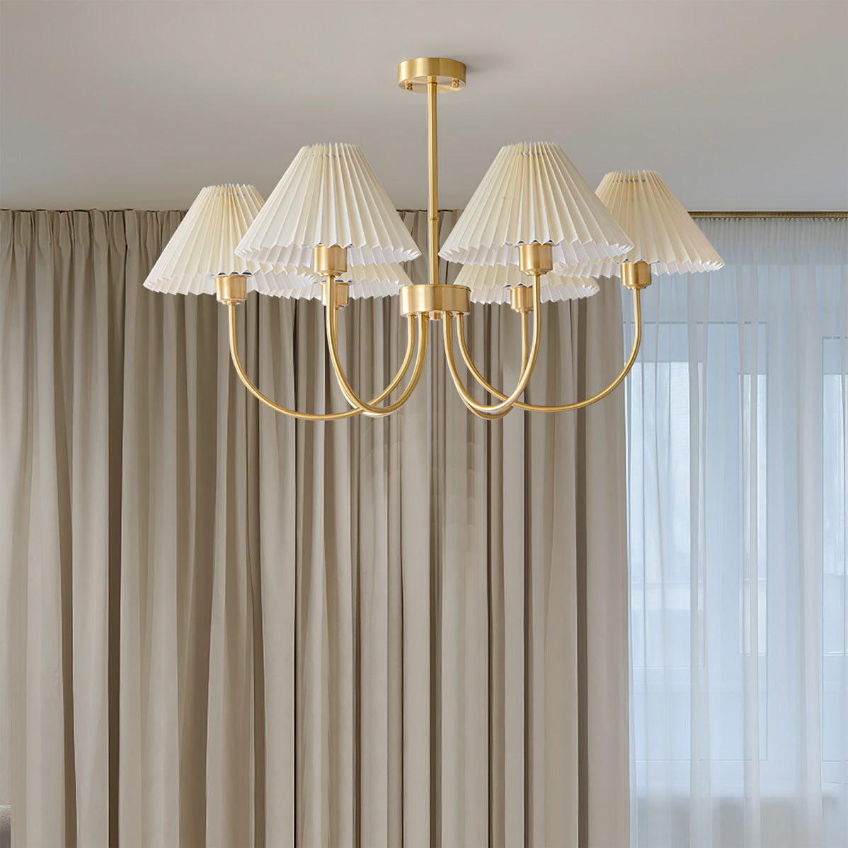 Modern brass chandelier with four pleated white shades in a stylish living room, YH Lamps