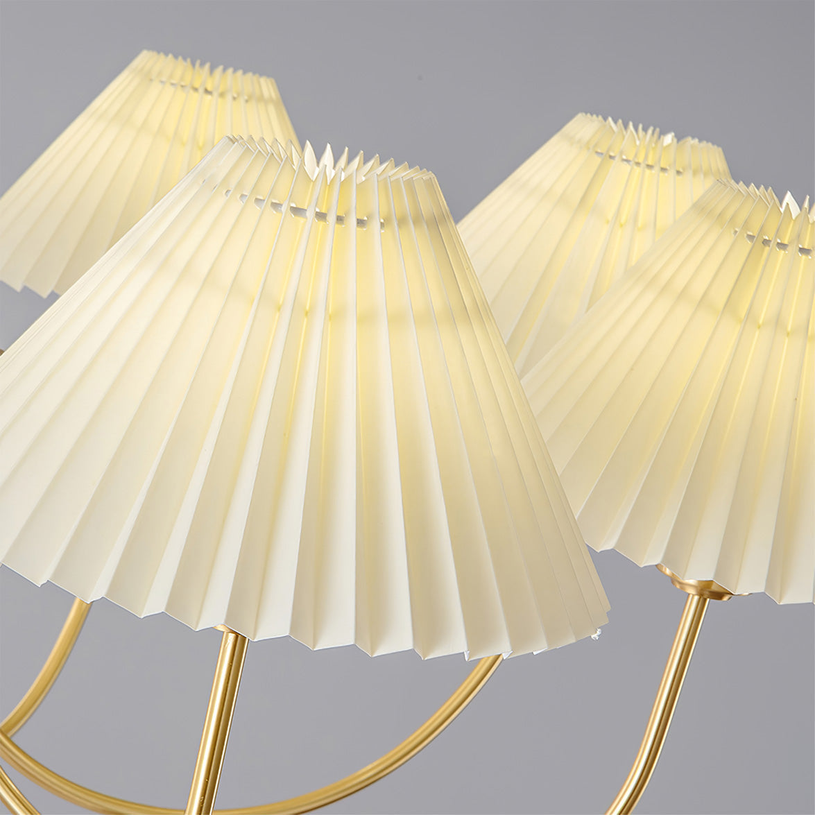 Modern brass chandelier with four pleated white shades by YH Lamps