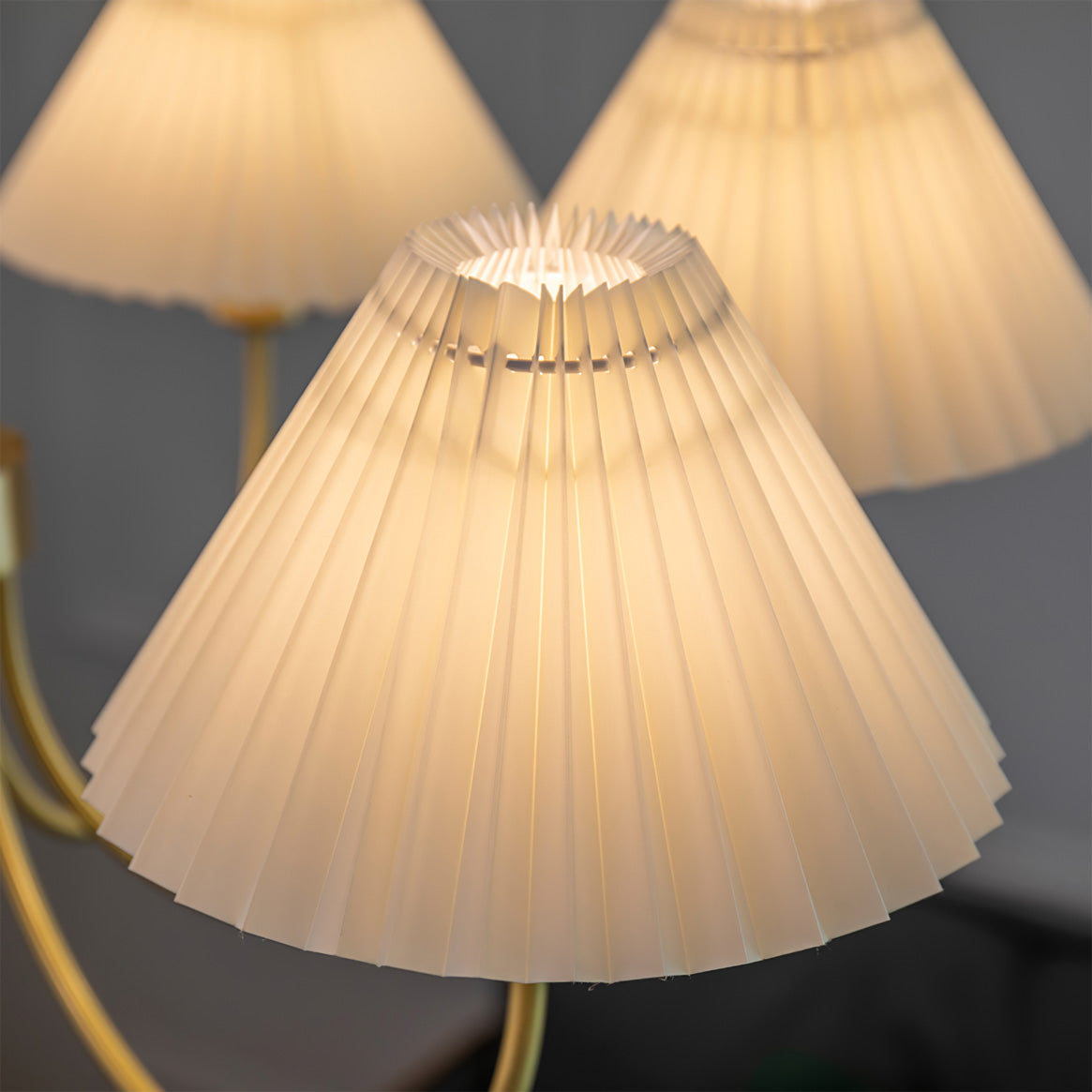 Modern brass chandelier with pleated white lamp shades, YH Lamps elegant lighting
