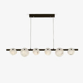 Modern linear chandelier with six round alabaster glass shades and brass finish, suspended by two cables