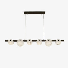 Modern linear chandelier with six round alabaster glass shades and brass finish, suspended by two cables