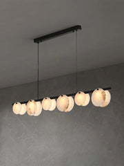 Modern linear pendant chandelier with round alabaster lampshades suspended from black ceiling mount