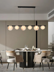 Modern dining room with black and white marble 5-head pendant chandelier and beige upholstered chairs