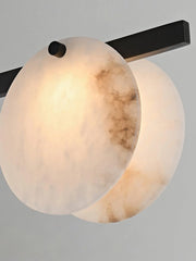 Modern wall sconce with two round alabaster stone lamps and black metal fixture