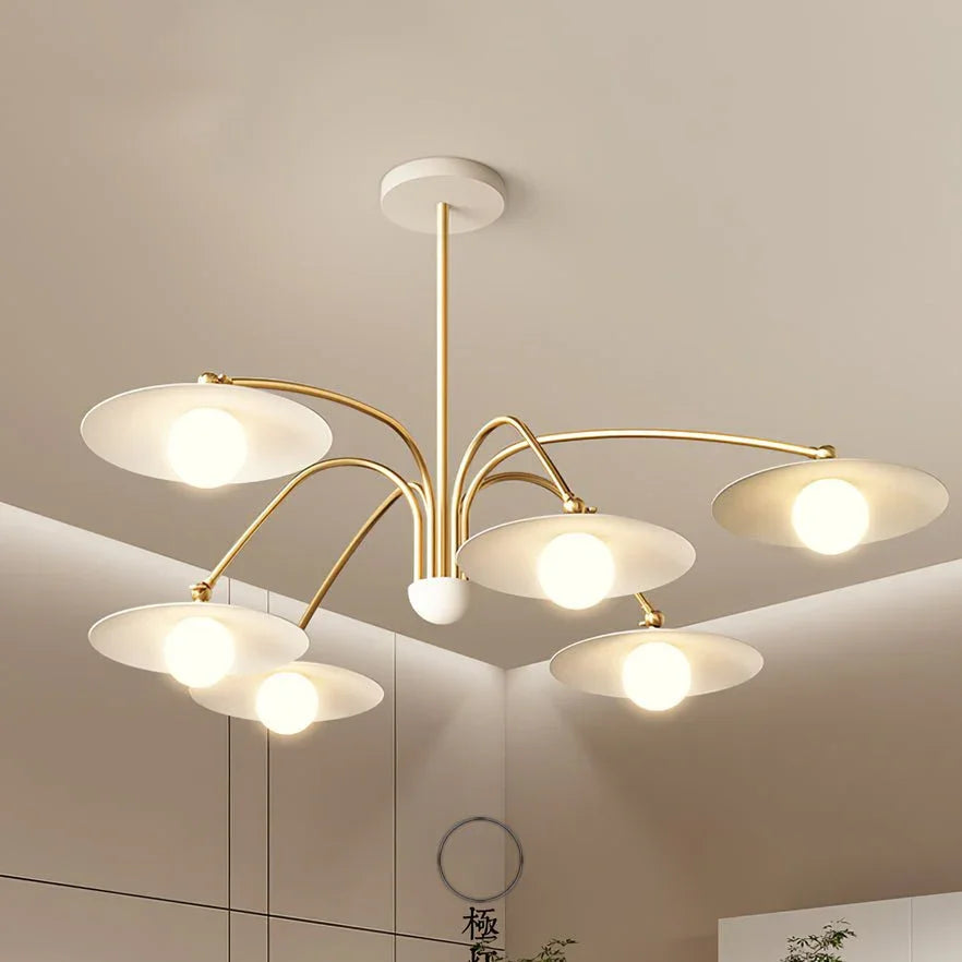 Modern 6-head gold and white pendant chandelier with round shades in a minimalist room