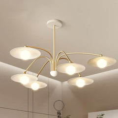 Modern 6-head gold and white pendant chandelier with round shades in a minimalist room